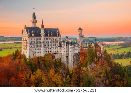 Beautiful sunset scene on Neuschwanstein Castle with colorful sky and autumn trees. Bavaria, Germany. Royalty-Free Stock Photo #517665211