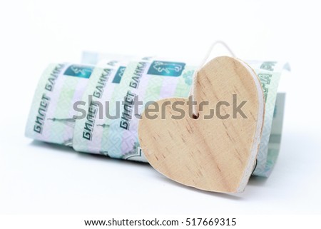 russian money and wooden heart symbol