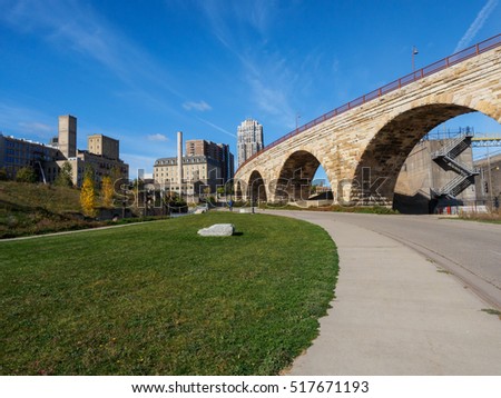 This is the Mill Ruins Park in Minneapolis, Minnesota. It features the Stone Arch Bridge and the ruins of flour mills.
