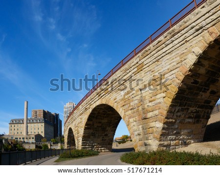 This is the Mill Ruins Park in Minneapolis, Minnesota. It features the Stone Arch Bridge and the ruins of flour mills.