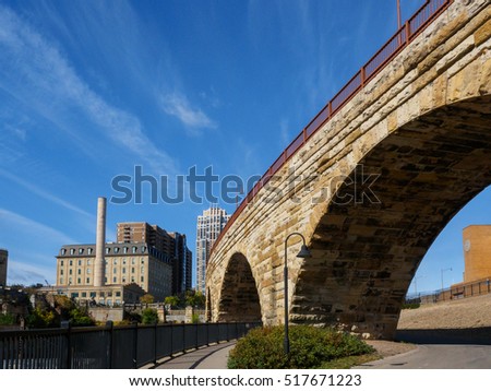 This is the Mill Ruins Park in Minneapolis, Minnesota. It features the Stone Arch Bridge and the ruins of flour mils.