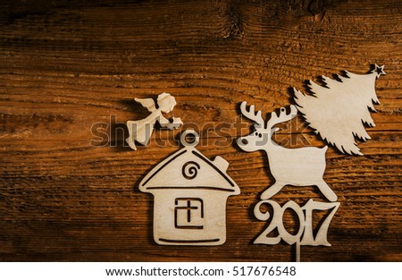 wooden angel with star above house, wood deer on 2017 happy new year. Christmas tree on deer. empty copy space for inscription 