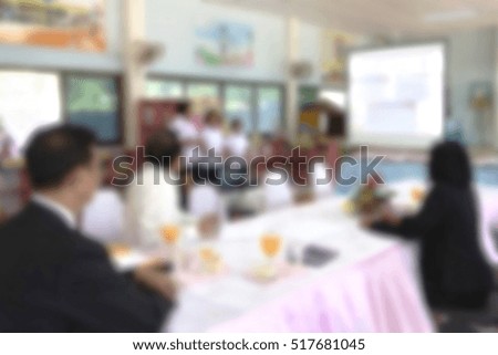 blurred classroom with presenting students and teachers