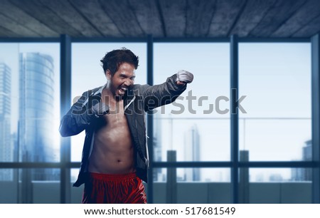 Young asian guy boxer workout in an modern gym with skyscraper view background