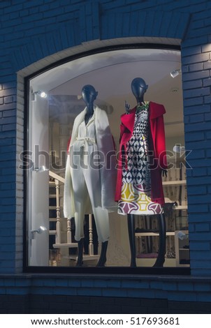 Female mannequins in fashionable dress on storefront