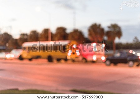 Blurred image of heavy traffic with defocused bokeh lights at rush hour at twilight. Out of focus traffic jam and street lights in Houston, Texas, US. Urban transportation problem abstract background.