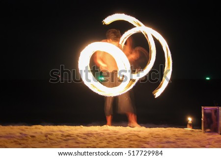 Amazing Fire Show at night on samet Island Holiday travelers. Slow shutter speed.