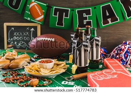 Game day football party table with beer, chips and salsa. Royalty-Free Stock Photo #517774783