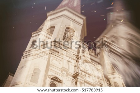 New Orleans St Louis Cathedral on Mardi Gras celebrations with confetti in the air.