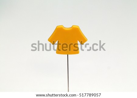 A miniature of a yellow shirt isolated white and blue background 