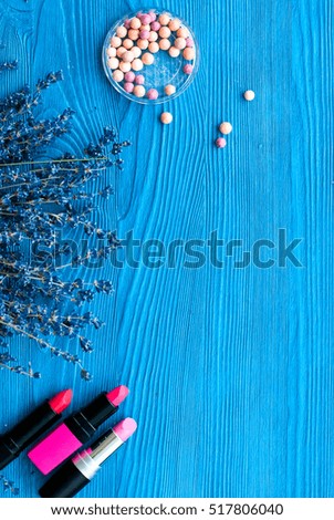 decorative cosmetics with lavender on wooden background top view