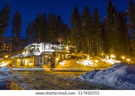 a group of rural houses in the winter night