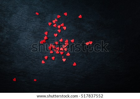 Beautiful valentines day background with red hearts on black background

