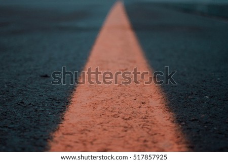 Asphalt road texture with orange stripe
