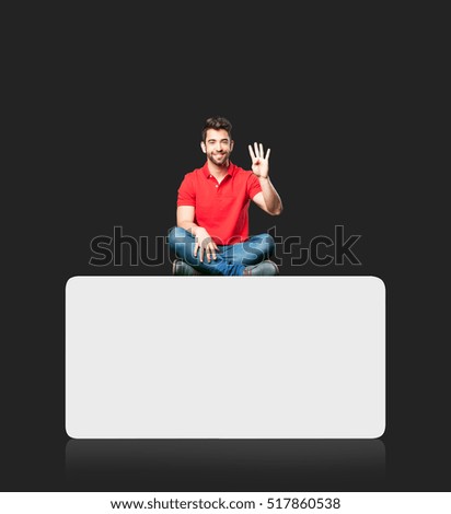 man sitting doing number four gesture