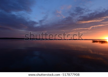 Evening sky at sunset over the lake water surface
