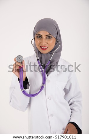 Arab female doctor in white coat holding stethoscope