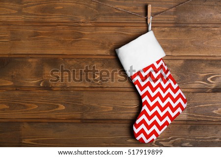 Christmas stocking hanging against wooden wall
