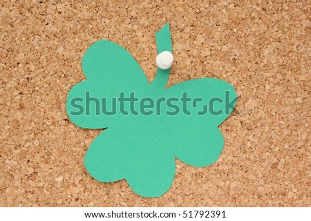 Shamrock post it note pinned to a cork board as a reminder for St Patrick's Day