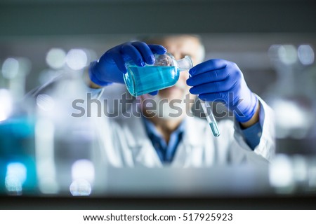 Senior male researcher carrying out scientific research in a lab (shallow DOF; color toned image) Royalty-Free Stock Photo #517925923