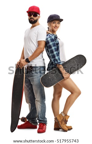 Full length portrait of a male and a female skater posing with a longboard and a skateboard isolated on white background