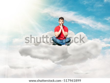 man sitting doing praying gesture