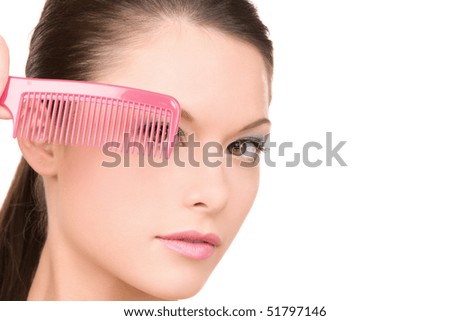 bright picture of beautiful woman with comb (focus on brush)