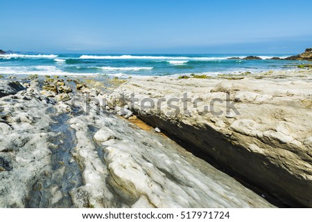 Rocky beach near cliffs in Ubiarco in Cantabria, Spain
