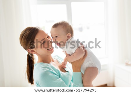 family, child and parenthood concept - happy smiling young mother with little baby at home Royalty-Free Stock Photo #517994293