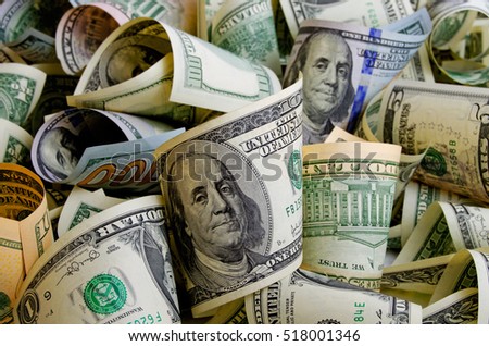 Cash dollars in various denominations on the plane. Royalty-Free Stock Photo #518001346
