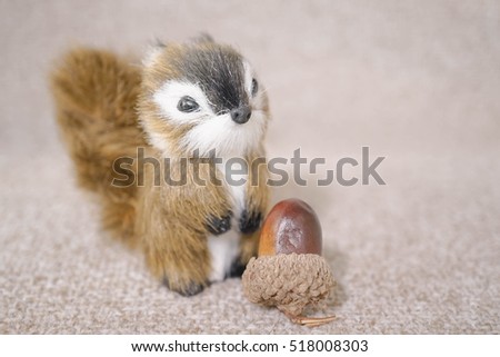 Realistic Miniature Squirrel, Animal Replica Prop Fur Toy, for Decoration, Selective Focus, isolated on soft brown background (copy space, empty space for text on the left)