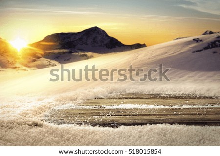 wooden desk of free space and winter with sunset 