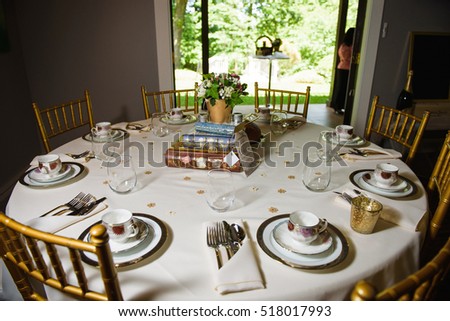 Round dinner table decorated with books