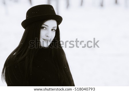 Woman winter snow nature portrait in black coat black and white