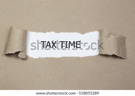 tax time message written under torn brown paper.
