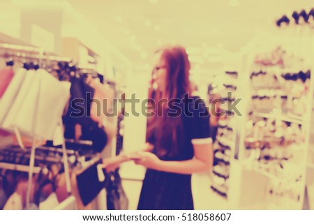 abstract blurred background of people in shop.