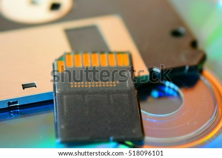 Floppy disk, cd and memory card. Tilt-shift effect applied. Macro.