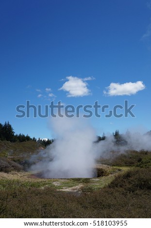 White cloud of steam coming out of a crater