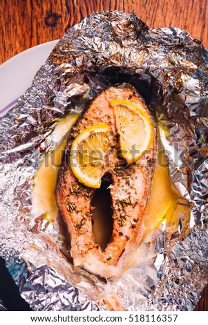 fish steak baked with lemon and herbs  in foil