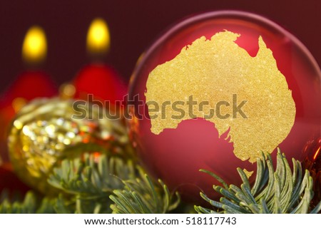 A glossy red bauble with the golden shape of Australia.(series)