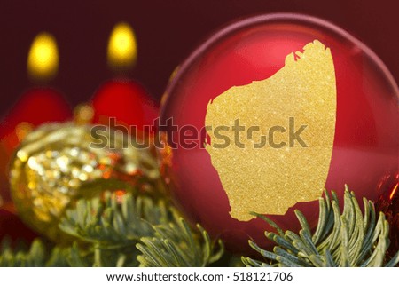 A glossy red bauble with the golden shape of Western Australia.(series)