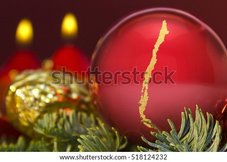 A glossy red bauble with the golden shape of Chile.(series)