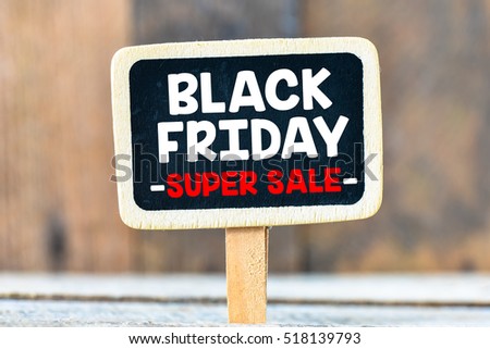 Black Friday handwritten with white chalk on a blackboard on a wooden background