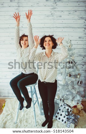 beautiful and funny twins with curly hair having fun together