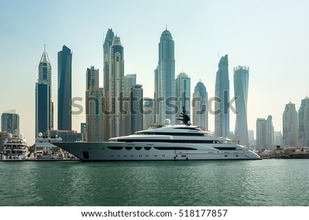 Luxury yacht and scyscrapers in center of Dubai, Unidet Arab Emirates. Dubai Marina in a summer day, United Arab Emirates. Royalty-Free Stock Photo #518177857