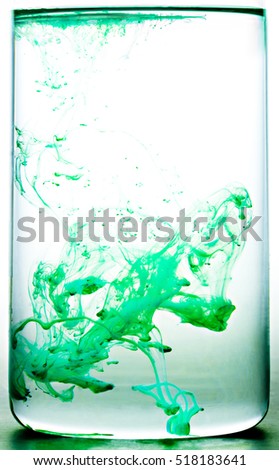 Green colored abstract drop in water in motion. Cloud of acrylic ink under water paint background. Colorful ink in water paint drops.