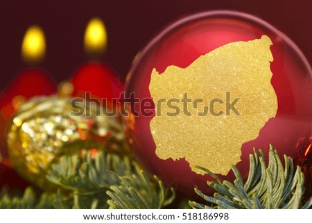A glossy red bauble with the golden shape of San Marino.(series)