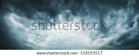 Dramatic Sky Background. Stormy Clouds in Dark Sky. Moody Cloudscape. Panoramic Image Can Be Used as Web Banner or Wide Site Header. Toned and Filtered Photo with Copy Space. Royalty-Free Stock Photo #518193517