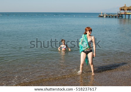 a woman with a child on the beach, sea, summer