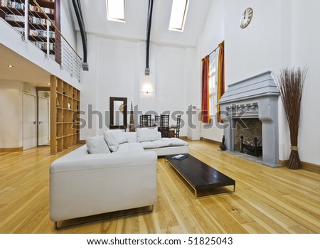 massive living room with double high ceiling and mezzanine